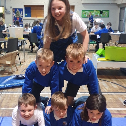 Children forming a human pyramid and having fun