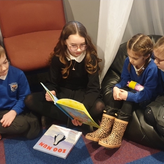 Children reading in lounge area of SAYCA centre